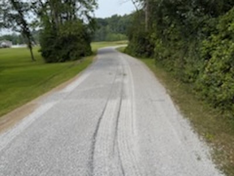 A regraded gravel lane running along a field edge