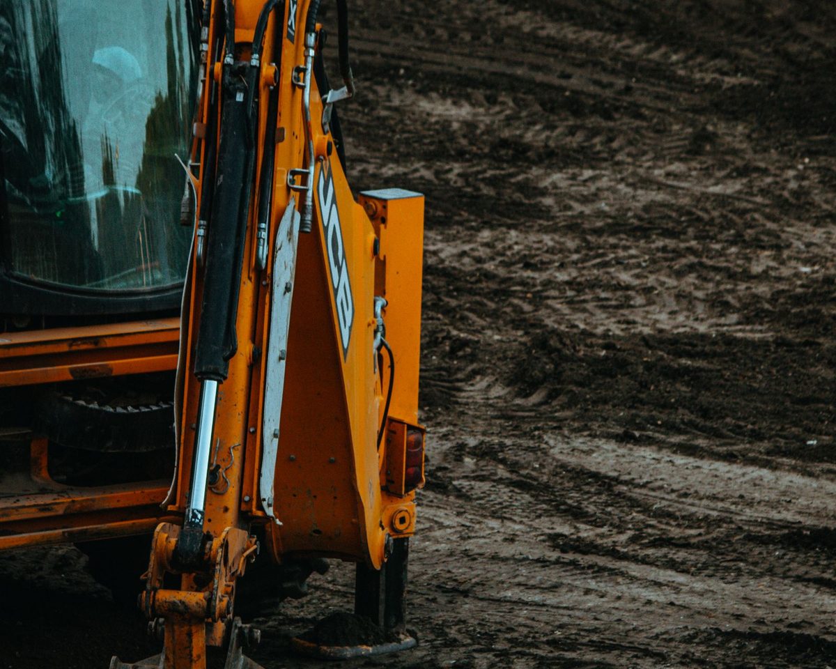 A backhoe on freshly opened ground